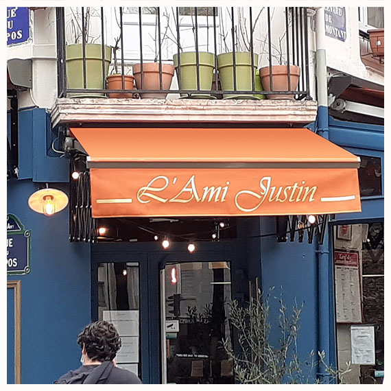 Rentoilage de stores banne de restaurant à Paris - Le Store Parisien